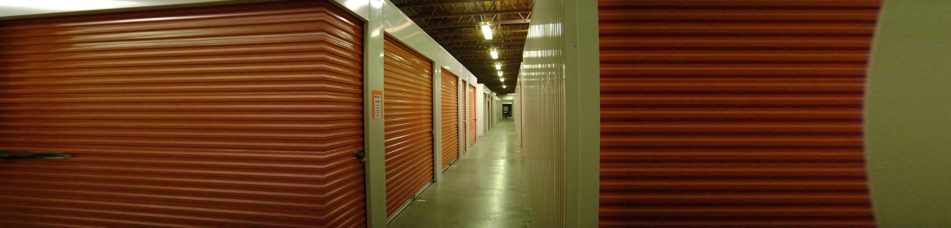 Indoor, air-conditioned self storage hallway with roll-up doors in St. George, Utah